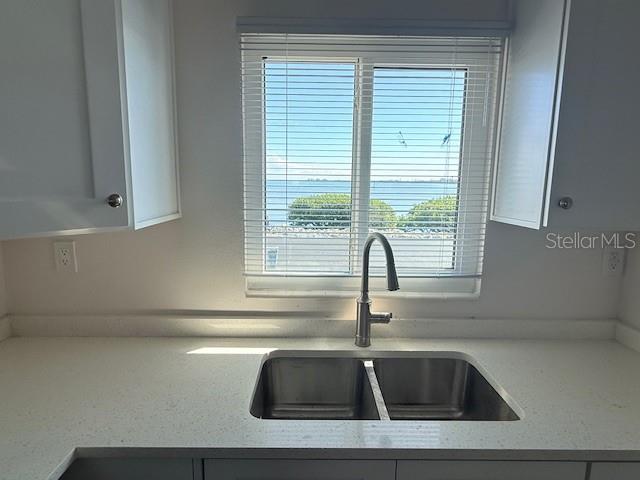 A kitchen sink with a gooseneck faucet sits before a window overlooking the water — 747 SAINT JUDES DRIVE S UNIT 2, LONGBOAT KEY, FL