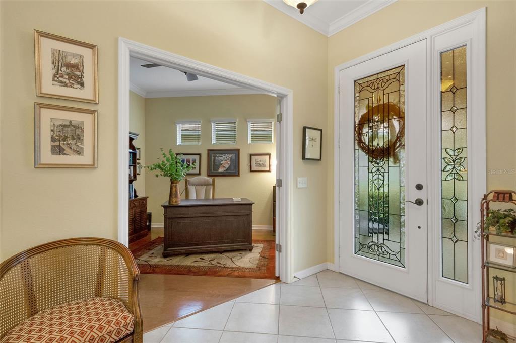 A foyer with tile flooring leads into a home office through a wide arched doorway — 2530 LAUREL GLEN DRIVE, LAKELAND, FL