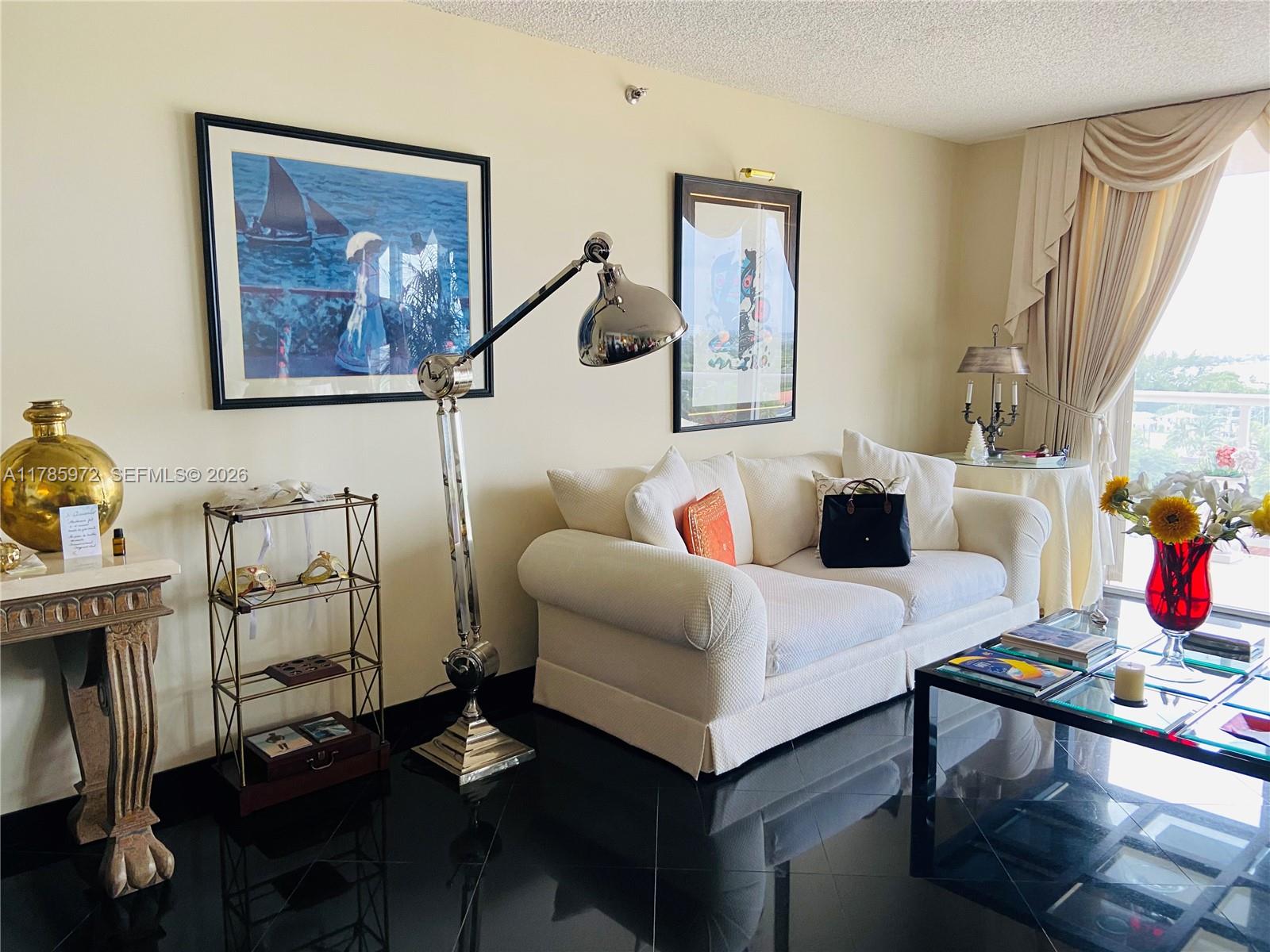 An elevated view shows a residential neighborhood with lush trees and a distant body of water — 8855 Collins Ave # 9E, Surfside FL 33154, SURFSIDE, FL