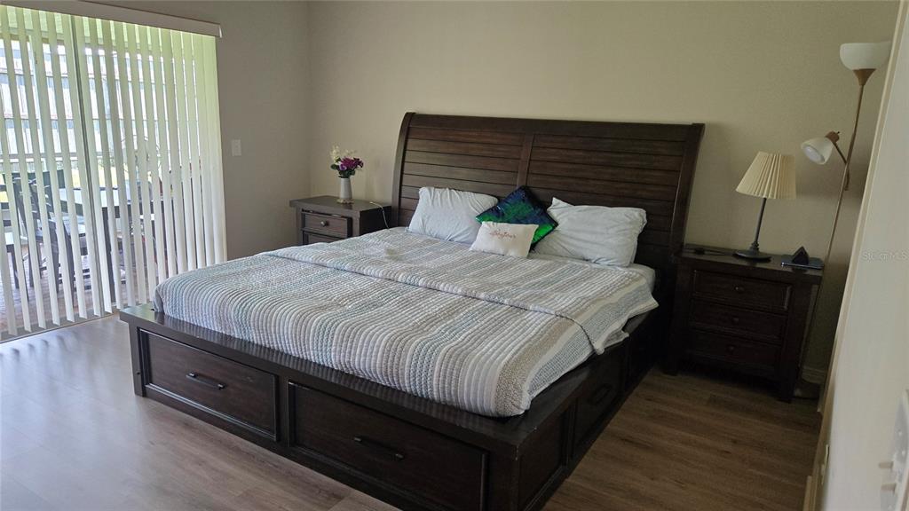 A bedroom features a desk with two computer monitors, a printer, and a single bed — 9765 FOX CHAPEL ROAD, TAMPA, FL