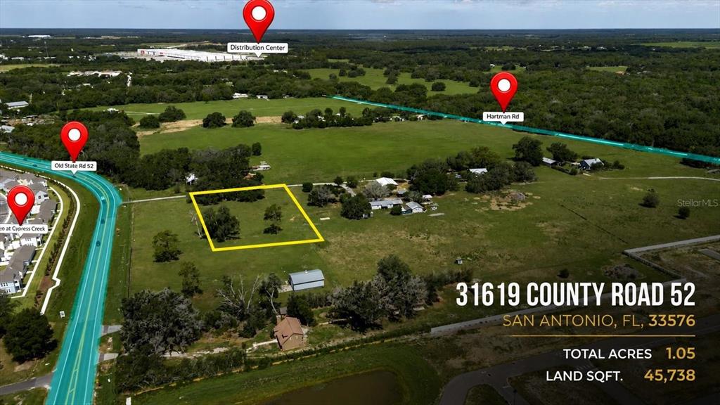 An aerial view shows a rectangular plot of land marked with a yellow outline — 31557 CR-52, SAN ANTONIO, FL