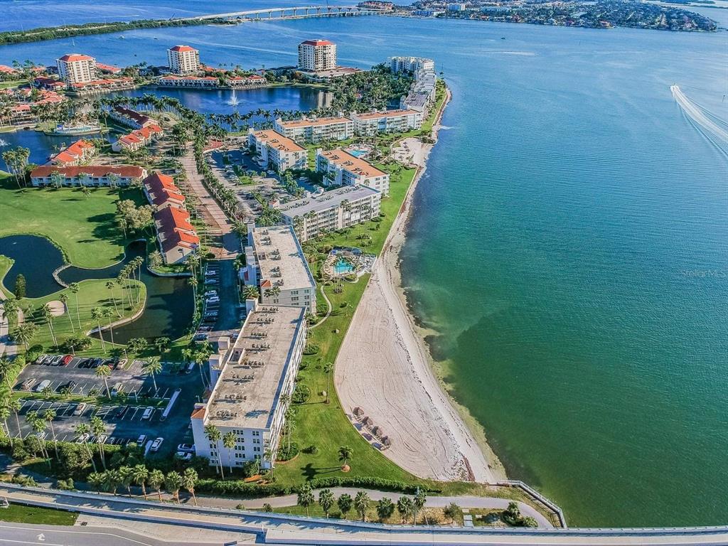 An aerial view of a coastal condominium complex with a beach, pool, and parking lot — 5901 BAHIA DEL MAR CIRCLE UNIT 422, ST PETERSBURG, FL