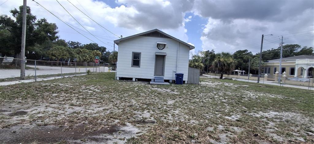 A white, single-story building with a metal door and a circular vent sits on a lot — 3009 N 13TH STREET, TAMPA, FL