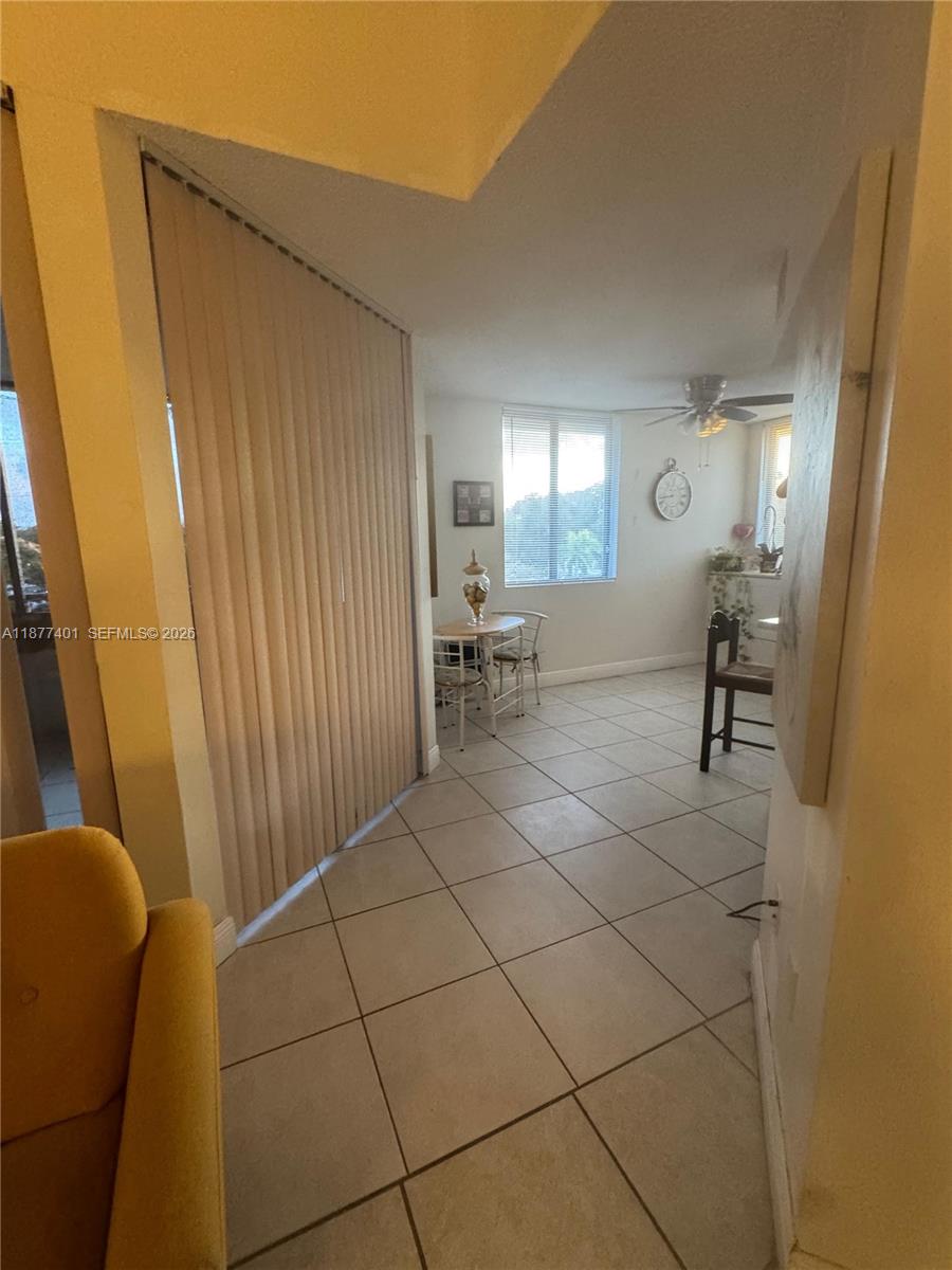 A tiled dining area features a small table, chairs, and vertical blinds by a window — 8205 SW 152nd Ave # 414, Miami FL 33193, MIAMI, FL