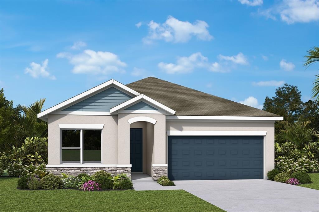 A modern kitchen with white cabinets, a central island, and wood-look flooring opens to a patio — 614 KINGSWOOD COURT, BRADENTON, FL