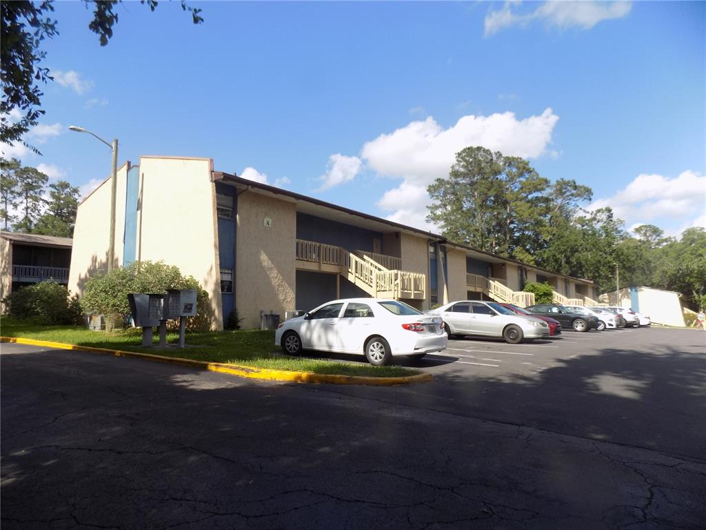 A two-story apartment building with exterior staircases and a parking lot in front — 2811 SW ARCHER ROAD UNIT x 201, GAINESVILLE, FL