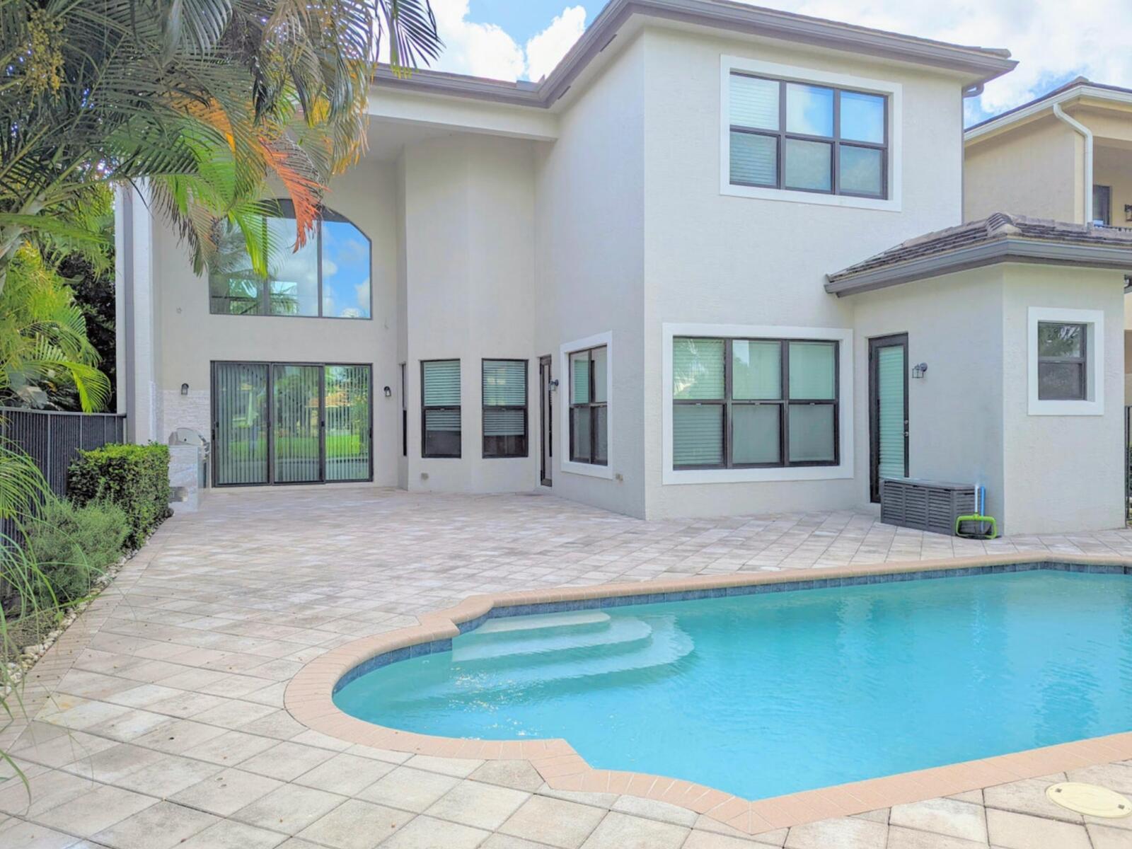 A two-story house with a paved patio and a swimming pool in the backyard — 16645 Germaine Drive, Delray Beach FL 33446, DELRAY BEACH, FL
