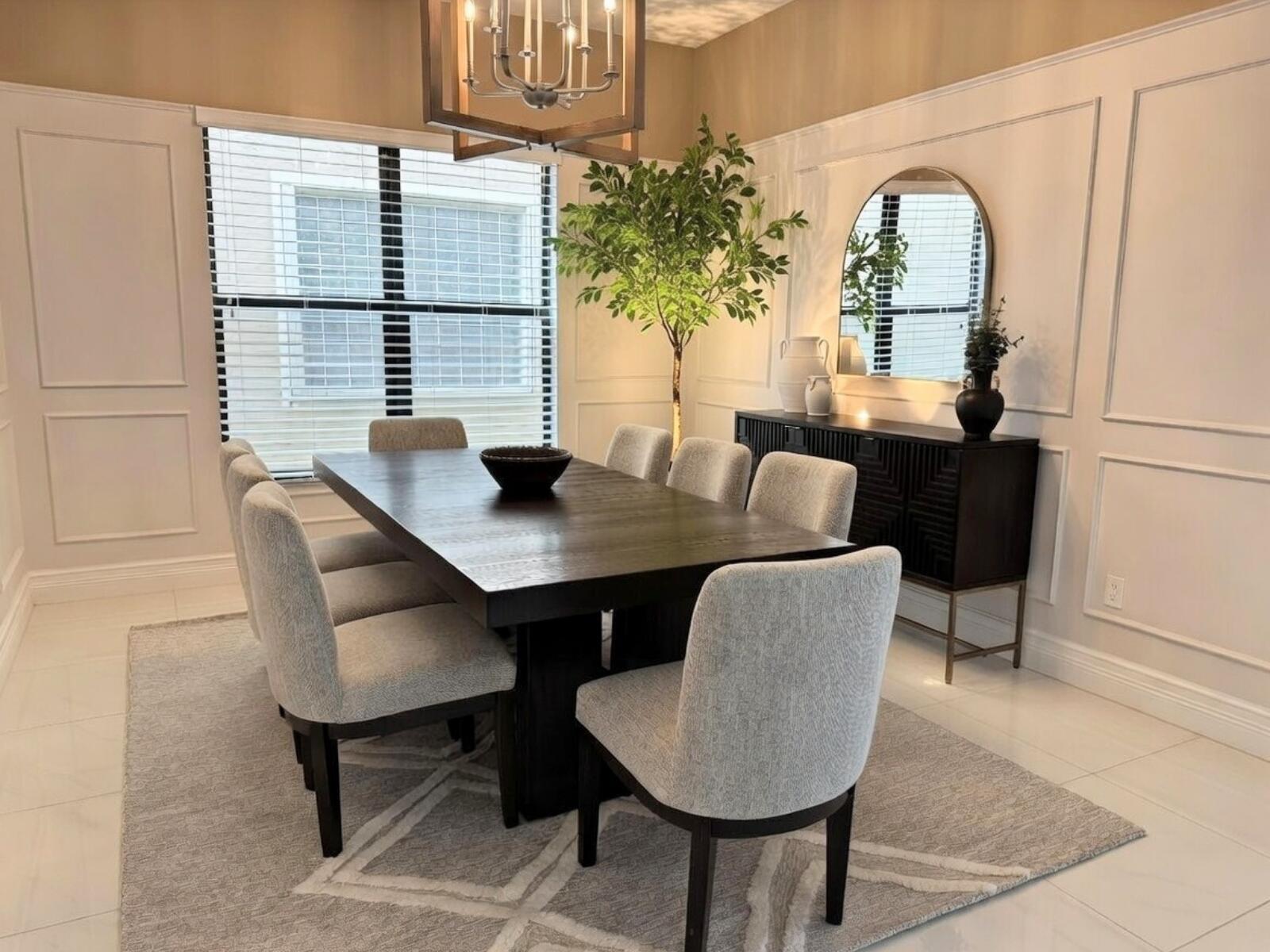 A dining room features a dark wood table, upholstered chairs, a sideboard, and wall molding — 16645 Germaine Drive, Delray Beach FL 33446, DELRAY BEACH, FL
