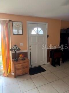 A light-colored front door with a glass insert stands in a room with tiled floors — 722 W WHIDDEN STREET, ARCADIA, FL