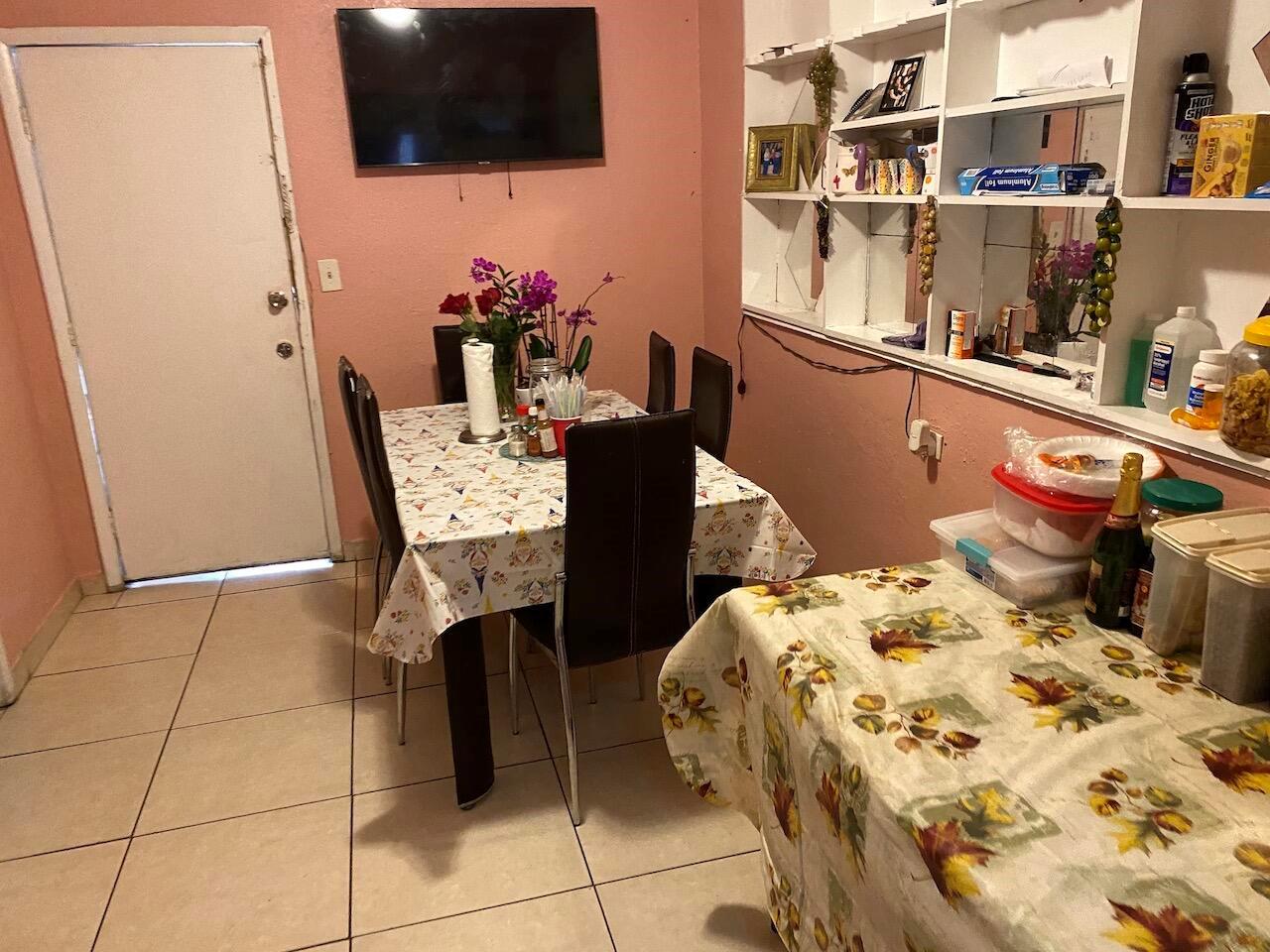 A dining room with a table, chairs, tile flooring, and built-in wall shelving — 12920 Westview Drive # 1, Miami FL 33167, MIAMI, FL