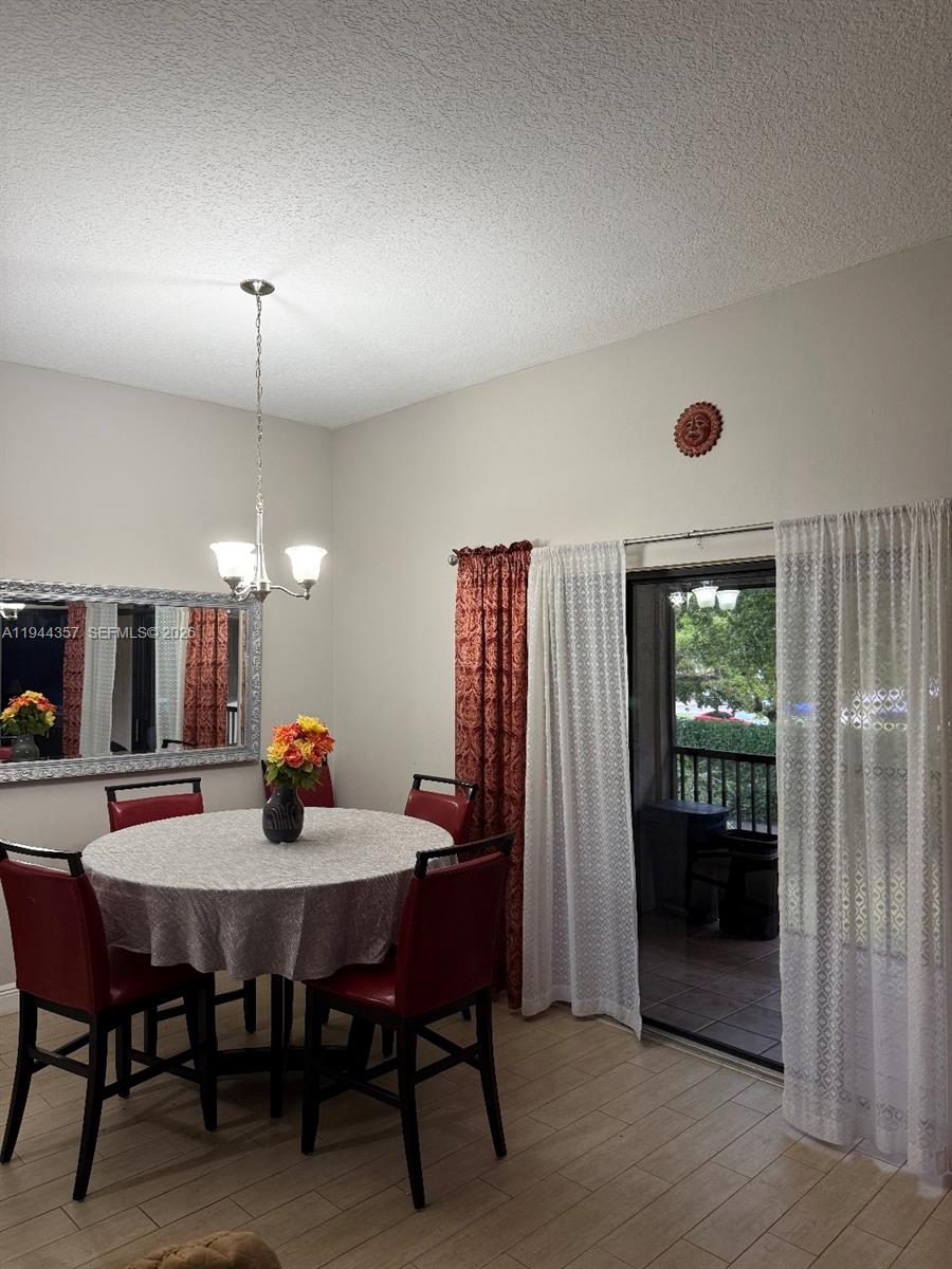A kitchen features gray shaker cabinets, stainless steel appliances, and light-colored countertops with a backsplash — 8019 NW 15th Mnr # 8019, Plantation FL 33322, PLANTATION, FL