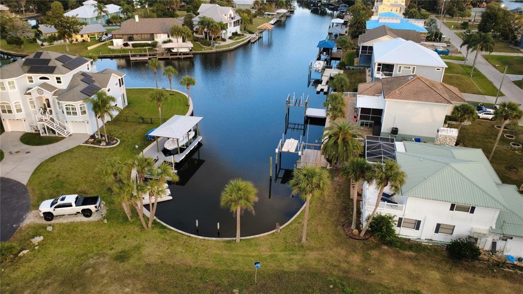 An aerial view shows waterfront homes with private docks along a canal — 11999 W BAYSHORE DRIVE, CRYSTAL RIVER, FL