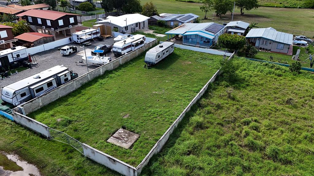 An aerial view shows a fenced, grassy lot containing a parked travel trailer — CARR 3301 W COMBATE, CABO ROJO, PR