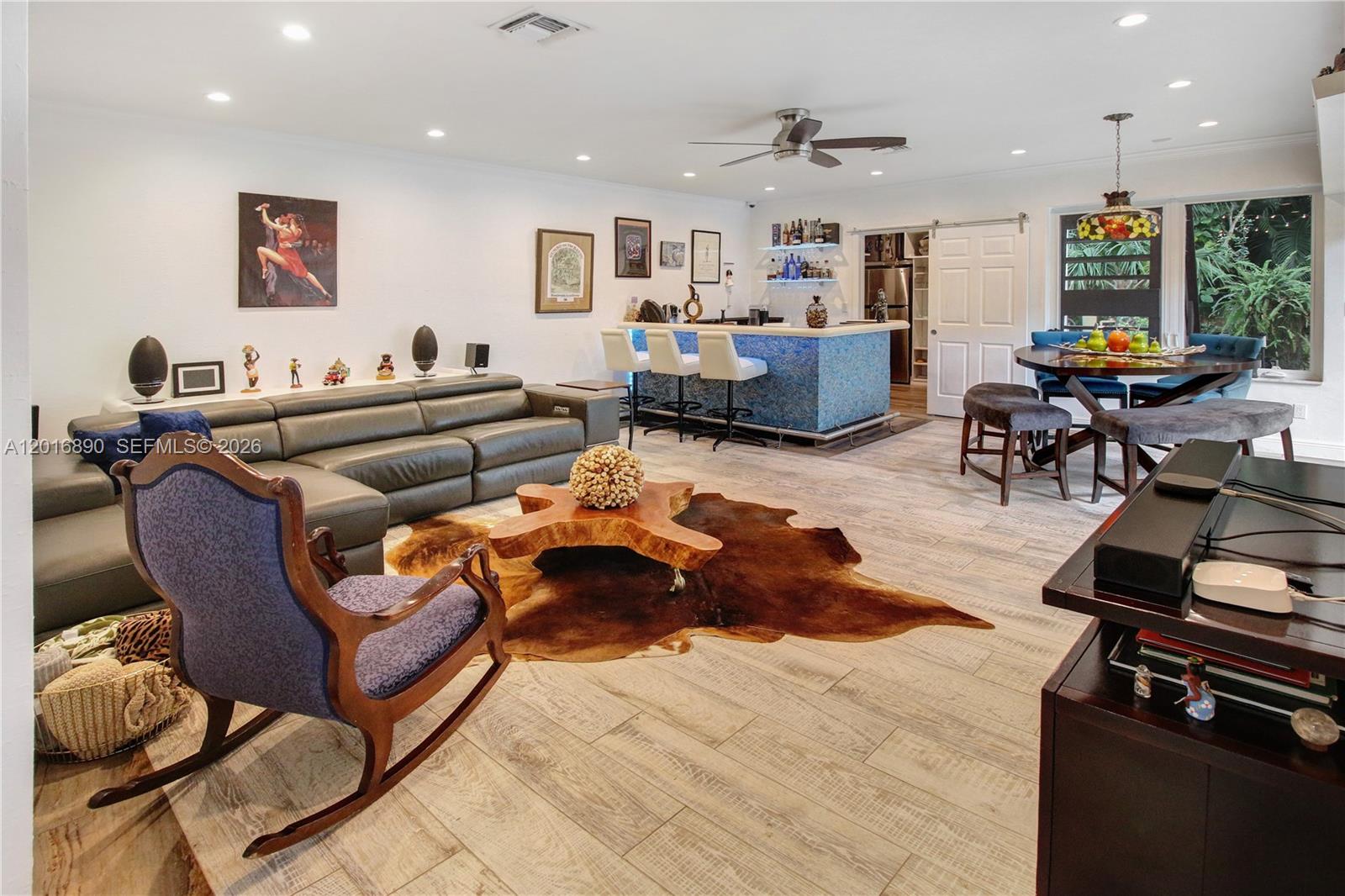 A living room features a leather sectional, a bar with stools, and a dining area — 19901 NE 21st Ave, Miami FL 33179, MIAMI, FL