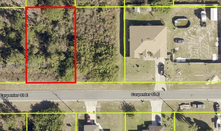 This aerial map shows a vacant, rectangular lot outlined in red along a paved road — 859 Carpenter St E, Lehigh Acres FL 33974, LEHIGH ACRES, FL