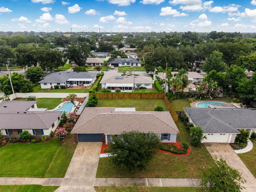 An aerial view of a suburban neighborhood featuring single-story houses with pools and green lawns — 4931 TELLSON PLACE, ORLANDO, FL