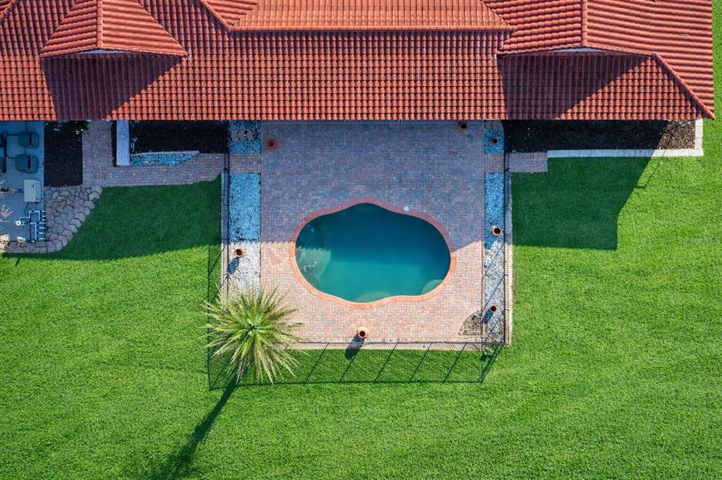An aerial view shows a house with a red tile roof and a backyard pool — 18910 NW 78TH AVENUE, ALACHUA, FL