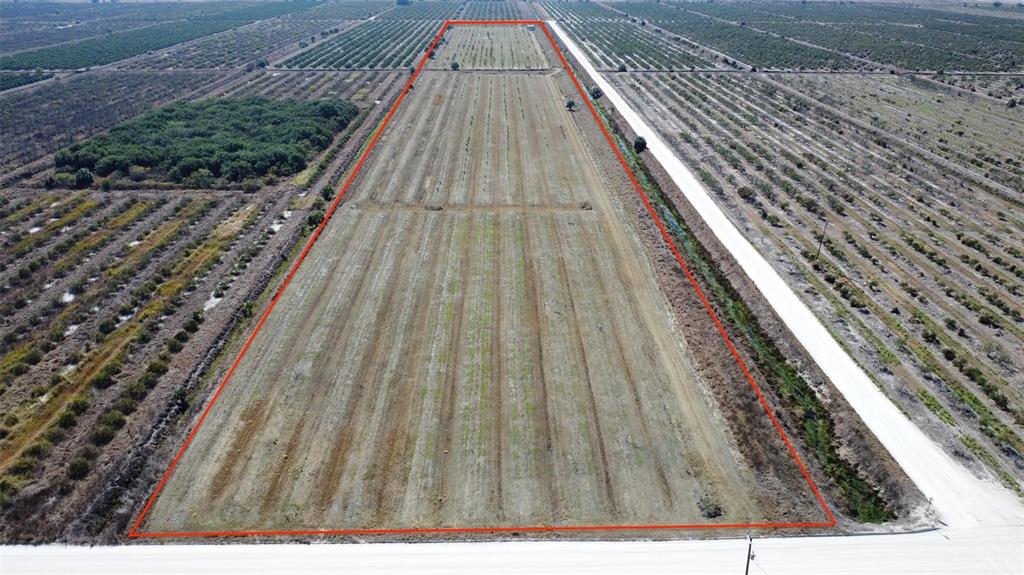 An aerial view shows a long, rectangular plot of agricultural land outlined in red — NE HWY 70, ARCADIA, FL