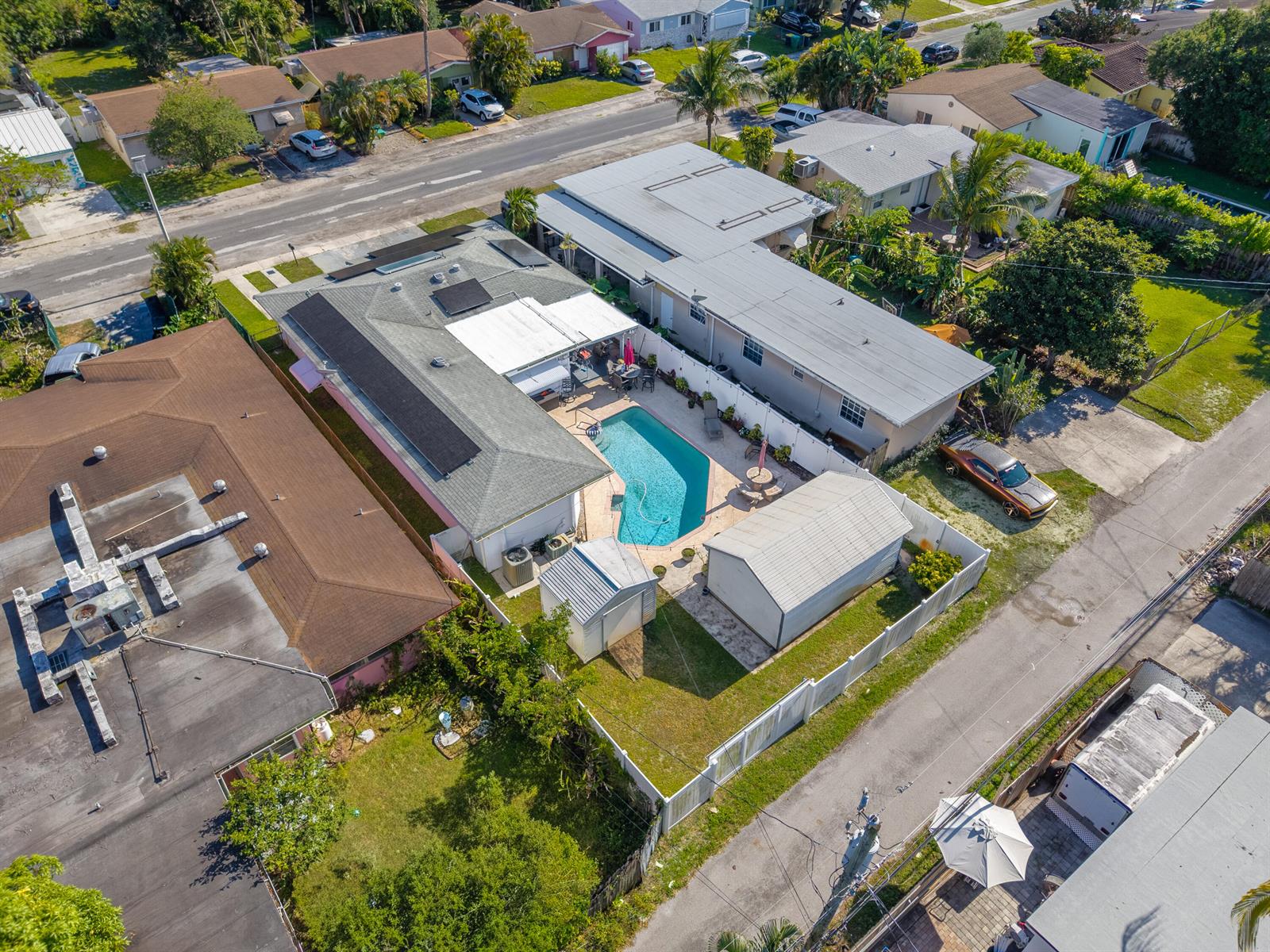 An aerial view shows a residential property with a swimming pool, patio, and detached shed — 262 SW 8th Street, Dania Beach FL 33004, DANIA BEACH, FL
