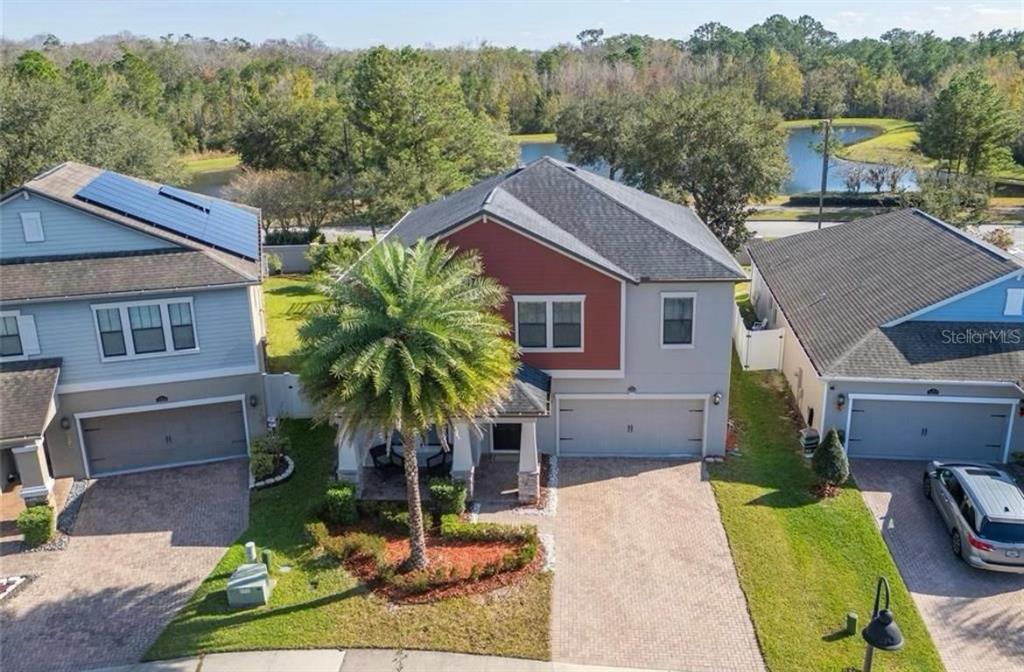 An aerial view of a two-story house with a red accent wall and a palm tree — 12273 GREAT COMMISSION WAY, ORLANDO, FL
