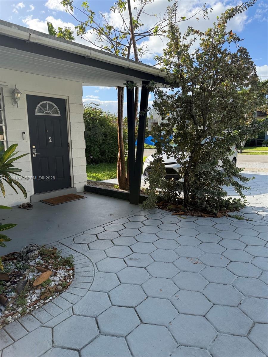 A dark front door with the number two is set under a covered porch area — 821 NE 6th St # 2, Hallandale Beach FL 33009, HALLANDALE BEACH, FL