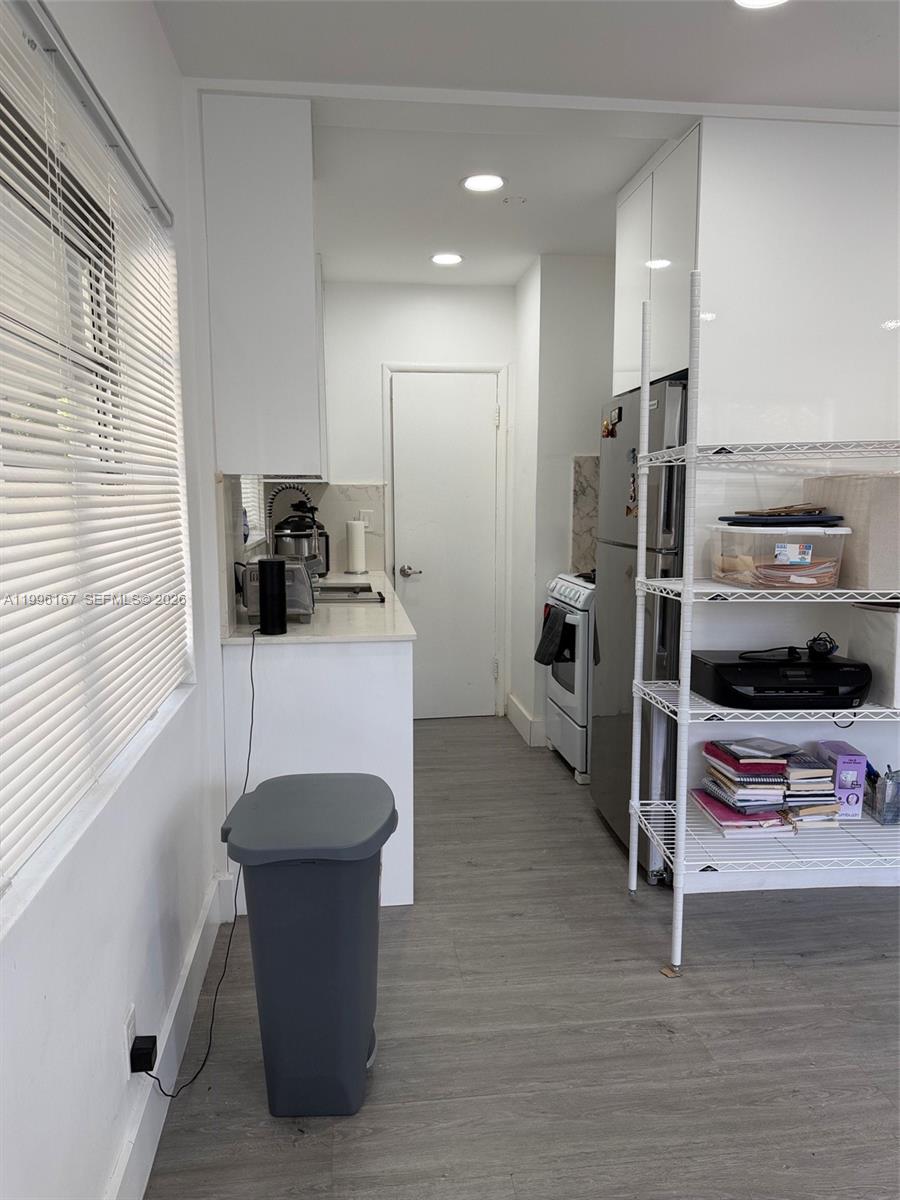 A kitchen features white cabinets, stainless steel appliances, and light-colored flooring — 821 NE 6th St # 2, Hallandale Beach FL 33009, HALLANDALE BEACH, FL
