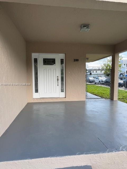 A covered front porch with a gray painted floor leads to a white front door — 200 NE 44th St # 0, Miami FL 33137, MIAMI, FL