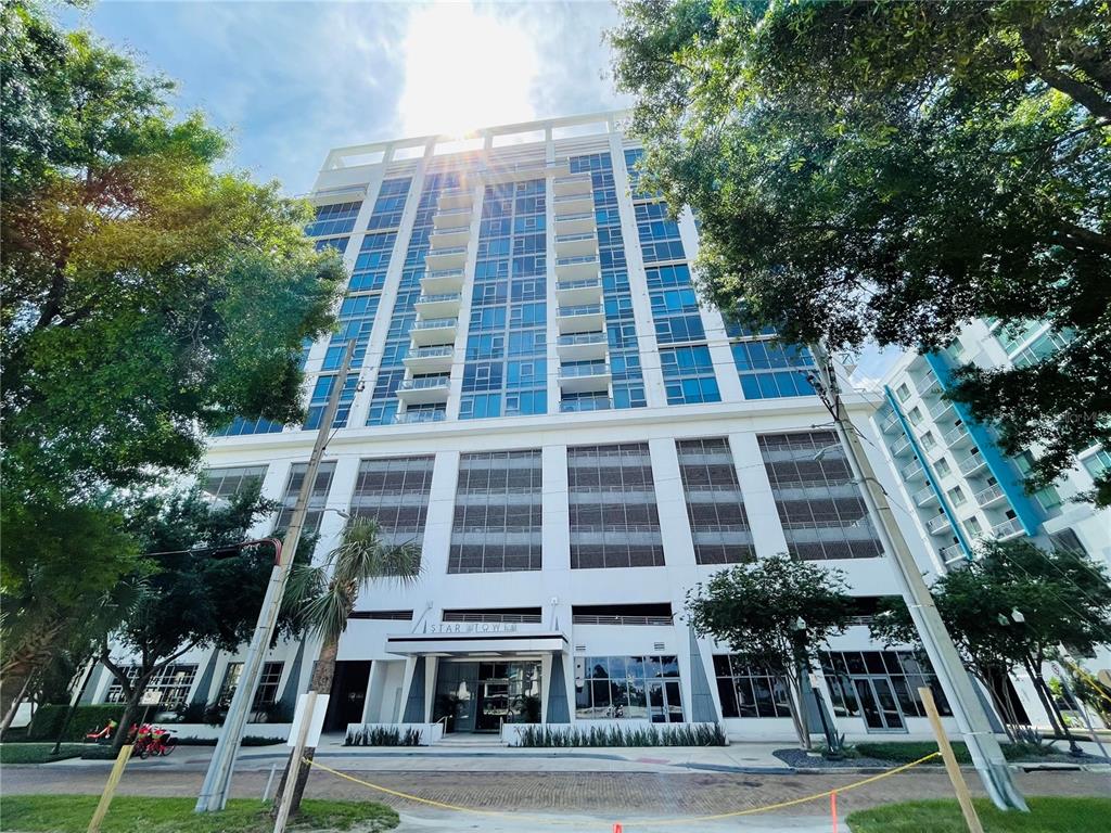A low-angle view of the exterior of the Star Tower high-rise building — 260 S OSCEOLA AVENUE UNIT 1102, ORLANDO, FL