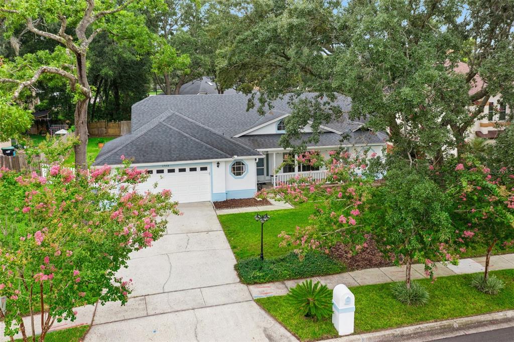 An aerial view of a single-story house with a white garage, porch, and mature trees — 1748 IMPERIAL PALM DRIVE, APOPKA, FL