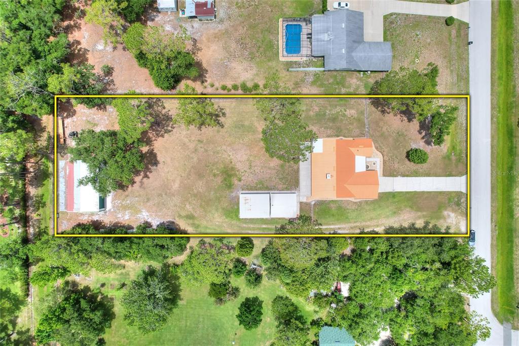 An aerial view shows a rectangular property lot containing a house, shed, and detached garage — 4520 LOG CABIN DRIVE, LAKELAND, FL