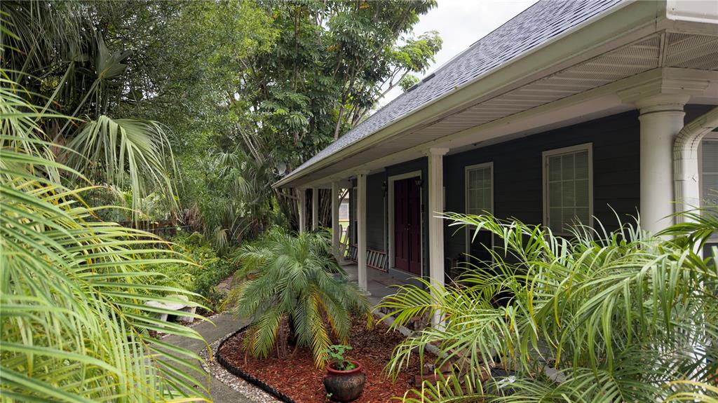 A sunroom features wood-paneled walls, tile flooring, two ceiling fans, and sliding glass doors — 6451 76TH TERRACE N, PINELLAS PARK, FL
