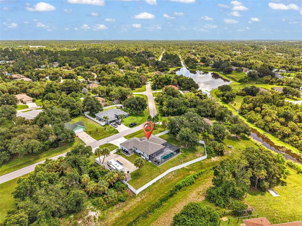 An aerial view shows a single-story house with a pool cage and a large yard — 3503 LAVILLA AVENUE, NORTH PORT, FL
