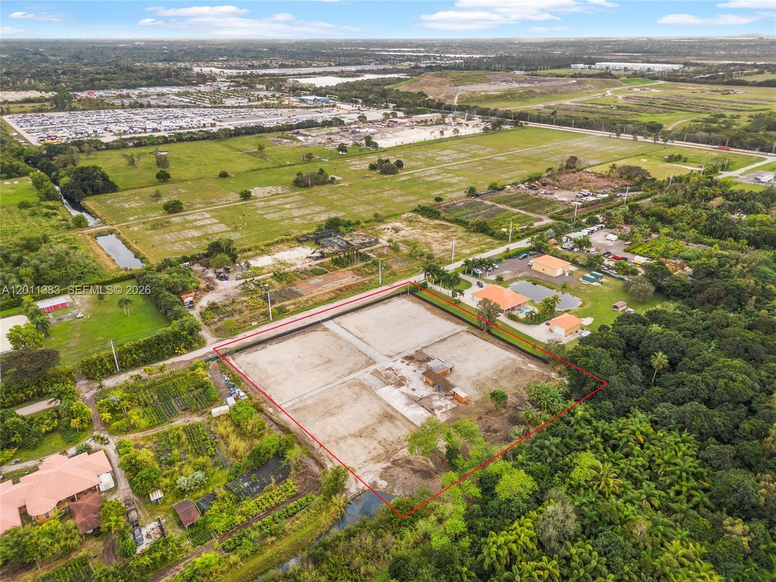 An aerial view shows a large, rectangular, cleared dirt lot outlined in red — 5601 SW 210th Ter, Southwest Ranches FL 33332, SOUTHWEST RANCHES, FL