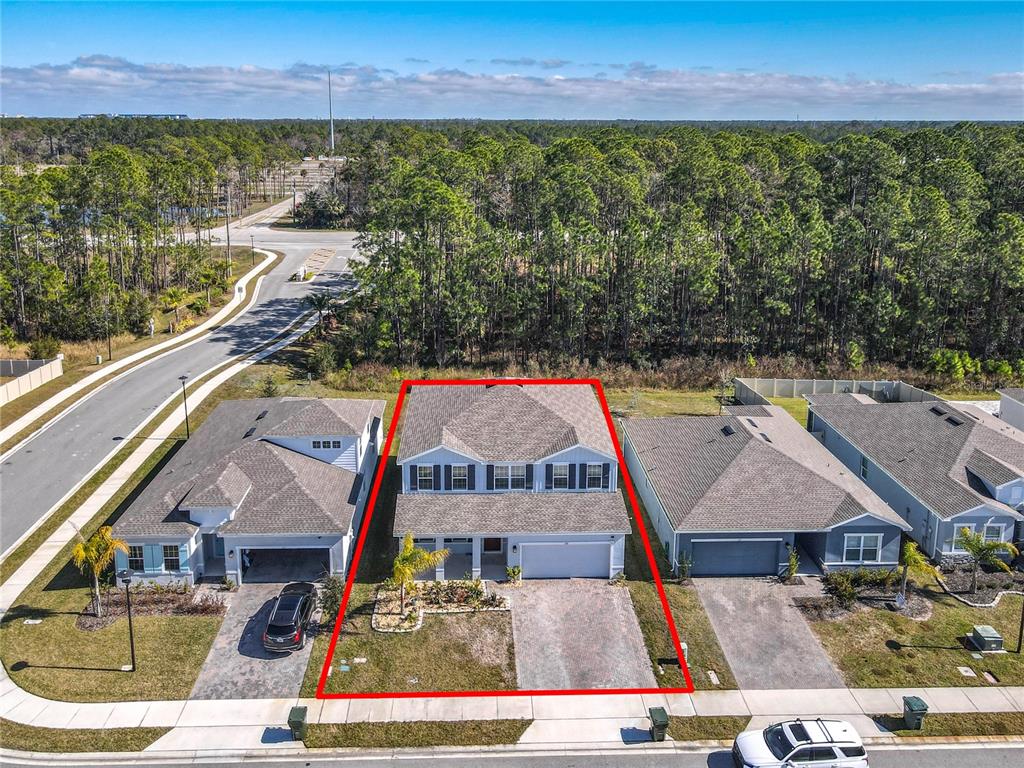 An aerial view shows a two-story suburban house outlined in red with a paved driveway — 121 EAGLE HARBOR WAY WAY, DAYTONA BEACH, FL