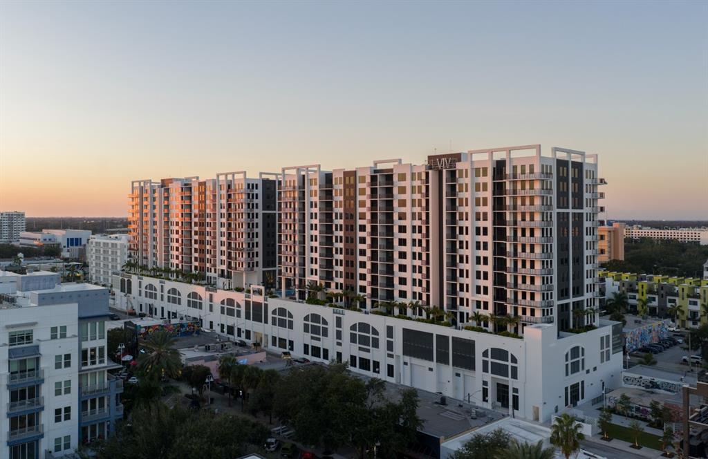 An aerial view of a large, modern multi-story apartment building at sunset — 1000 1ST AVENUE N UNIT ST, ST PETERSBURG, FL