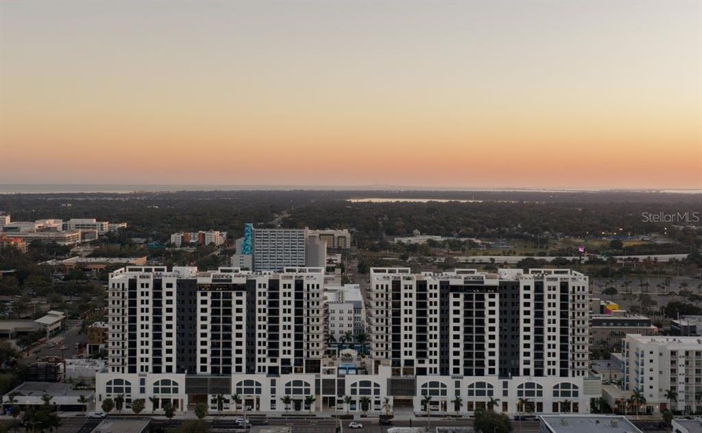An aerial view of a large, modern multi-story apartment complex at sunset — 1000 1ST AVENUE N UNIT ST, ST PETERSBURG, FL
