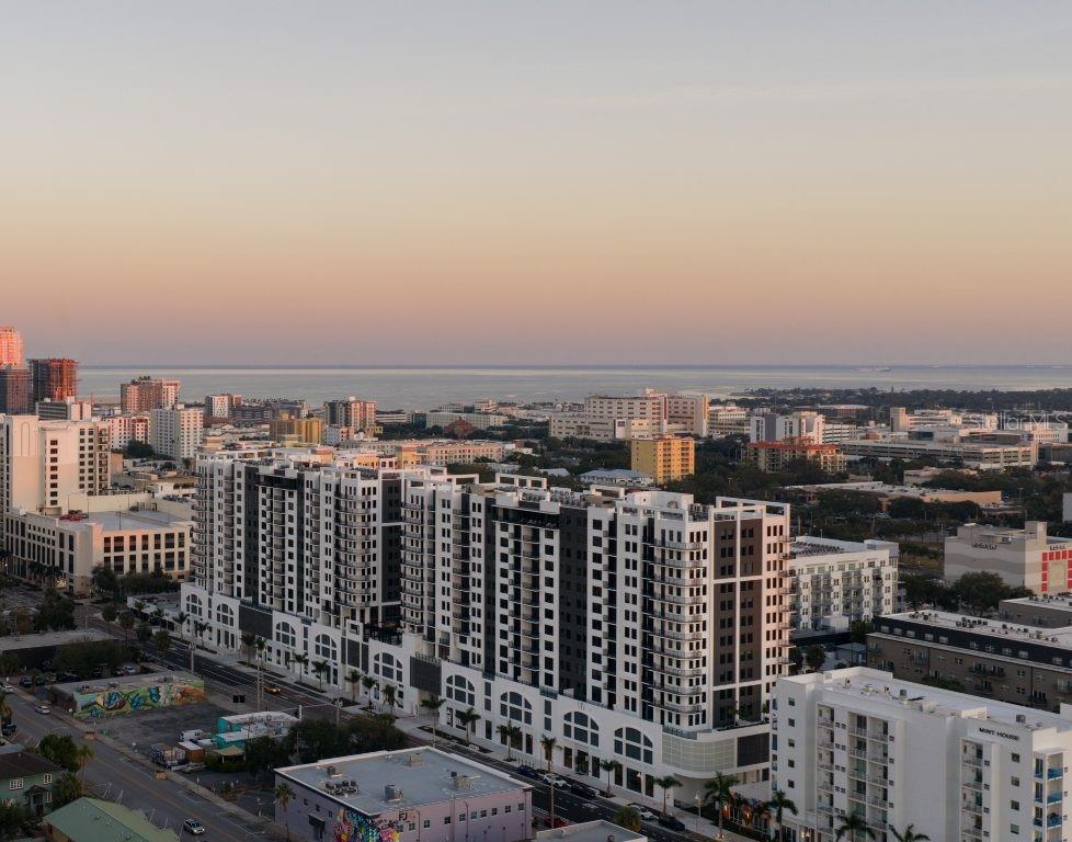An aerial view of a modern apartment complex overlooking a city skyline and the ocean — 1000 1ST AVENUE N UNIT ST, ST PETERSBURG, FL