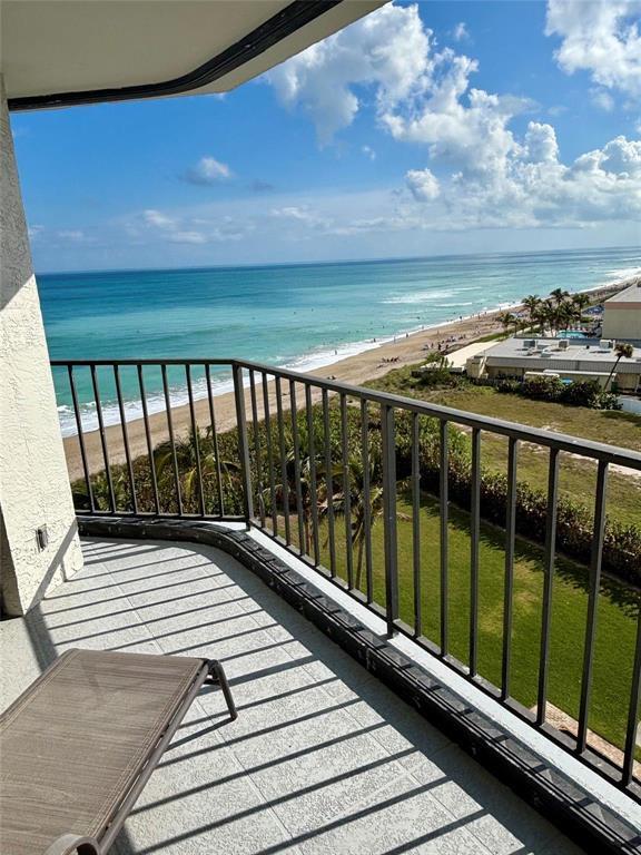 A balcony with a metal railing overlooks a beach and the ocean — 9650 S Ocean Drive S # 809, Jensen Beach FL 34957, JENSEN BEACH, FL