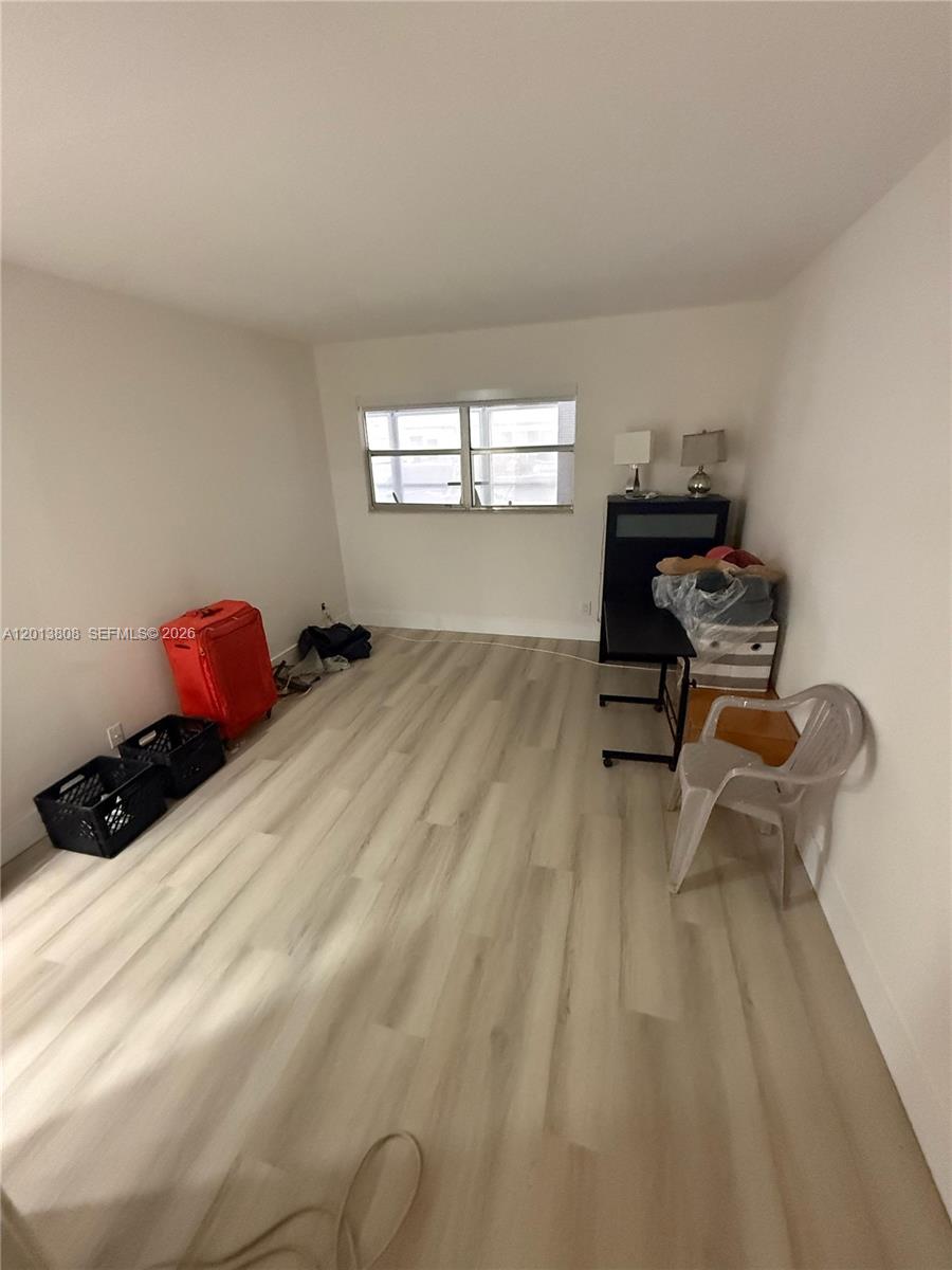 This room features light-colored wood-look flooring, white walls, and a single window — 200 E Monaco  E # 200, Delray Beach FL 33446, DELRAY BEACH, FL