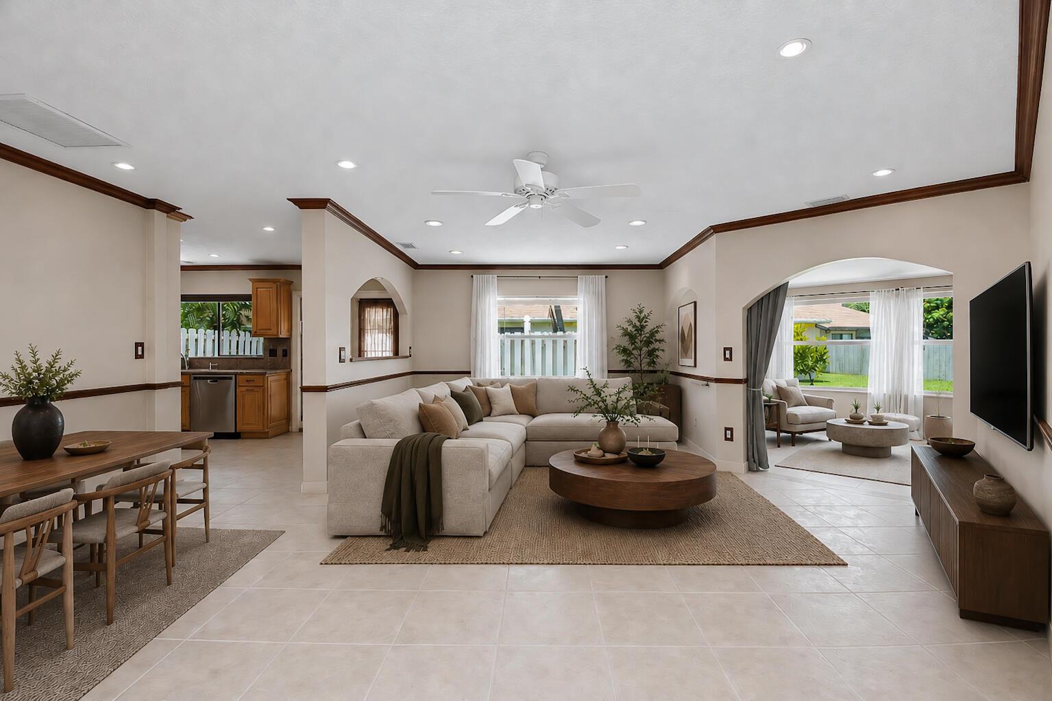 A living room with a sectional sofa, dining area, and kitchen visible in the background — 9709 Sunny Isle Circle, Boca Raton FL 33428, BOCA RATON, FL