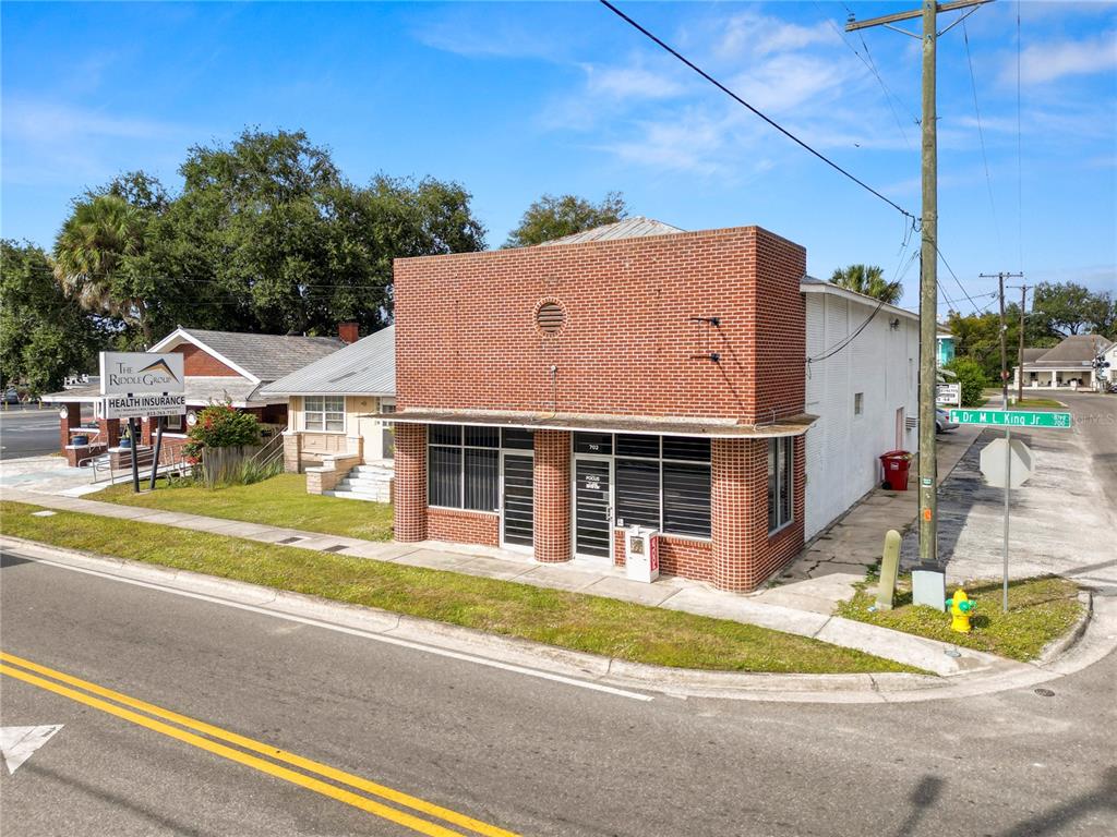 A red brick commercial building sits on a corner lot at a street intersection — 702 W DR MARTIN LUTHER KING JR BOULEVARD, PLANT CITY, FL