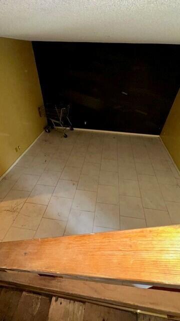 An empty room with light-colored tile flooring, yellow walls, and a black accent wall — 3162 N Pine Island Road, Sunrise FL 33351, SUNRISE, FL