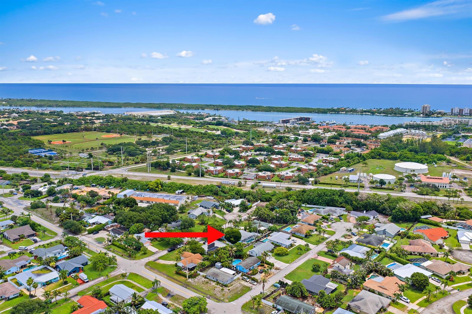 An aerial view shows a residential neighborhood with a red arrow pointing to a house — 76 Wingo Street, Tequesta FL 33469, TEQUESTA, FL