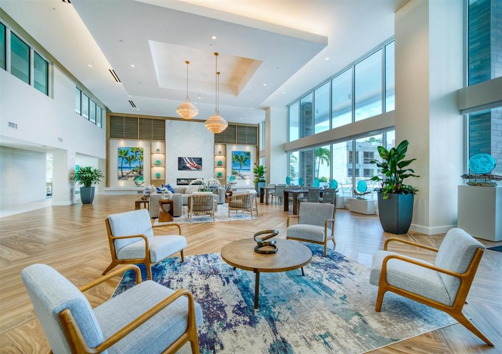 A spacious, modern lobby features a seating area, large windows, and light wood flooring — 900 N OSCEOLA AVENUE UNIT 401, CLEARWATER, FL