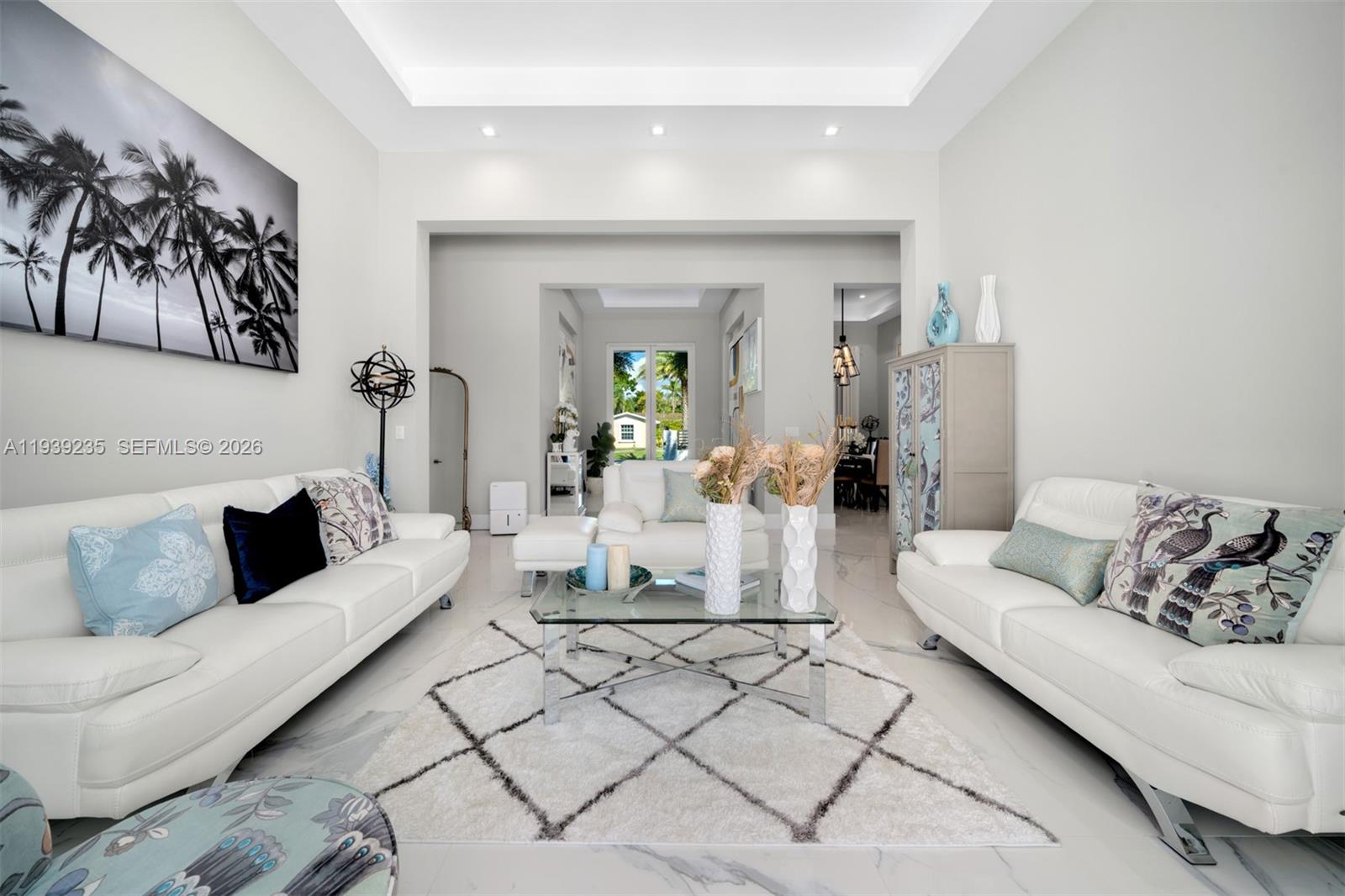 A bright living room features white leather sofas, a glass coffee table, and a patterned rug — 10250 SW 135th St, Miami FL 33176, MIAMI, FL
