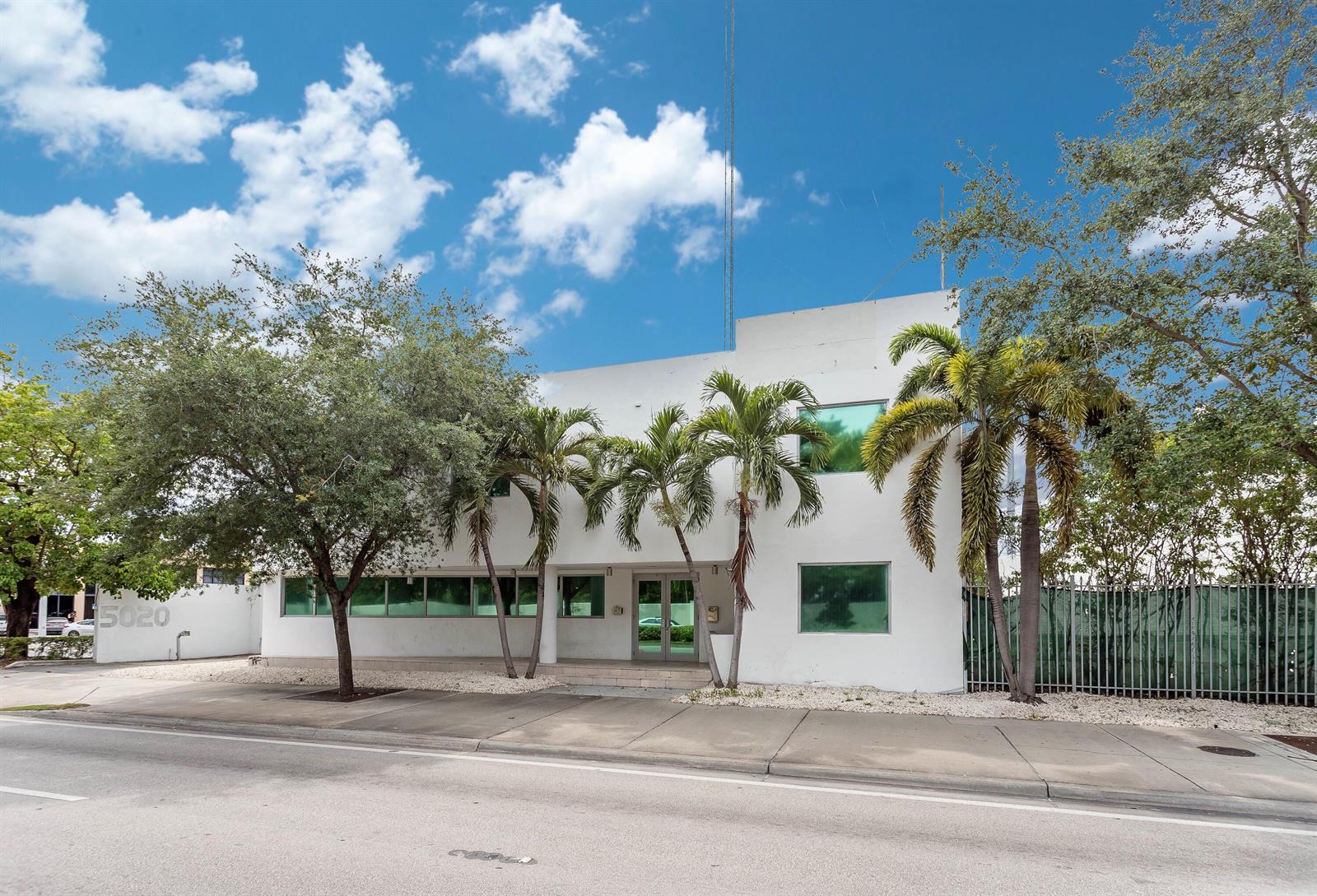 A two-story white commercial building with palm trees and a sidewalk in front — 5020 Biscayne Boulevard, Miami FL 33137, MIAMI, FL