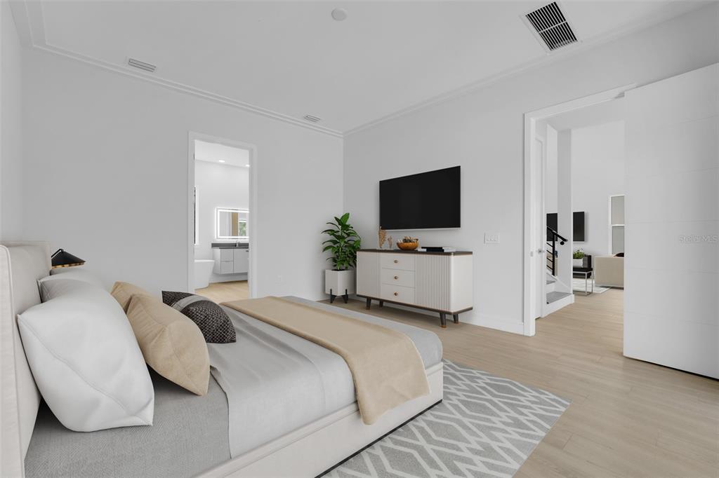 A modern bedroom features a bed, a white dresser with a television, and light flooring — 3036 KENSINGTON AVENUE, DAVENPORT, FL