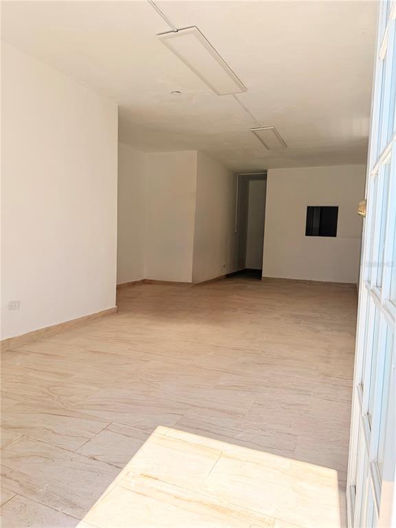 An empty room with light-colored tile flooring, white walls, and rectangular ceiling light fixtures — Calle 601 BLOQUE 224 COMERCIAL 1, CAROLINA, PR