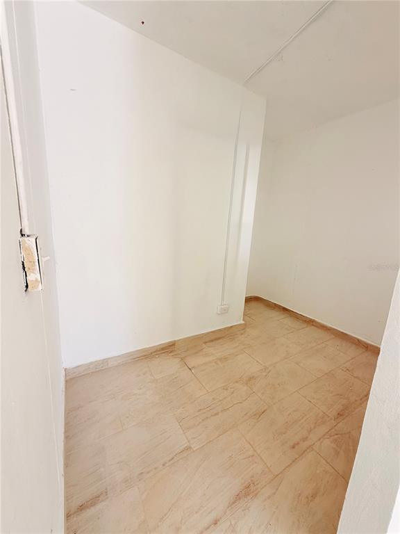 An empty, small room with white walls and light-colored rectangular floor tiles — Calle 601 BLOQUE 224 COMERCIAL 1, CAROLINA, PR