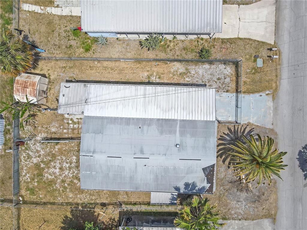 An aerial view shows a mobile home with a metal roof and surrounding yard space — 11309 LEISURE LANE, PORT RICHEY, FL